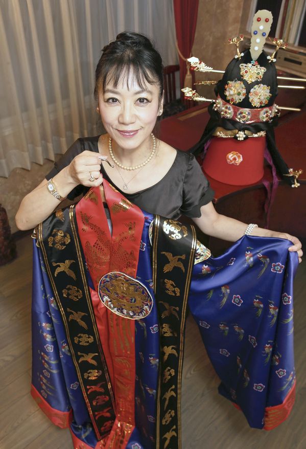 Chon Wolson posing with her costume. Photo courtesy of The Japan News.