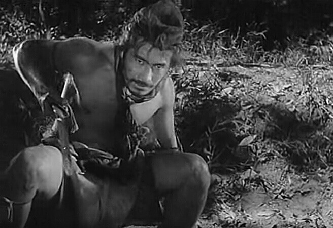 Toshiro Mifune as the cowering Tajomaru