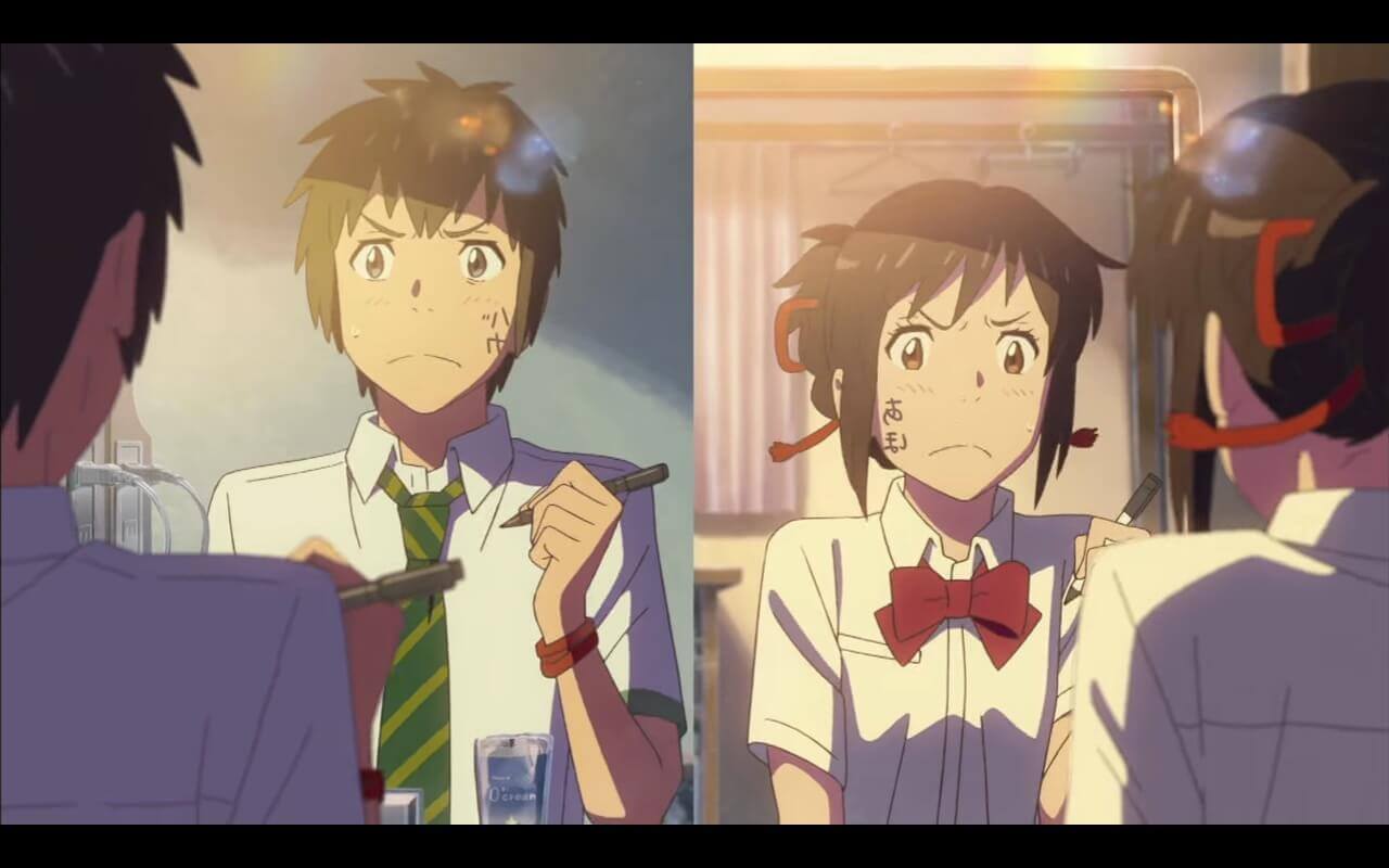 Your Name Review Mitsuha and Taki look at themselves in their mirrors.
