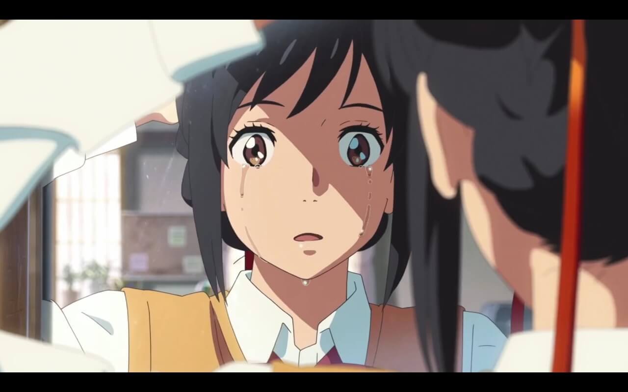 Your Name Review Mitsuha crying while tying her hair up.