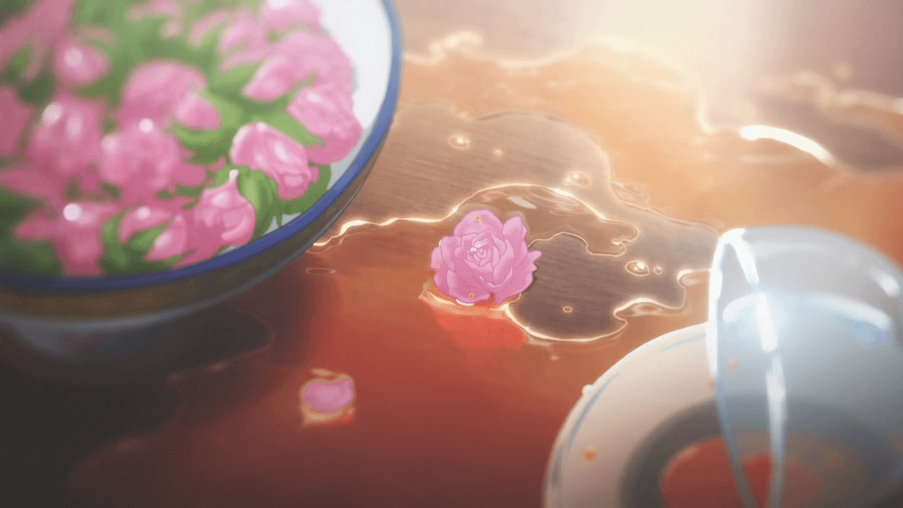 A screenshot of spilled water on a table next to a bowl of flowers