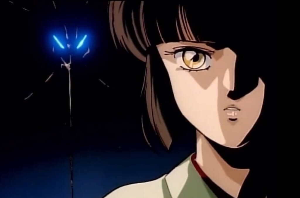 Close up of the face of Vampire Princess Miyu with blue glowing eyes behind her