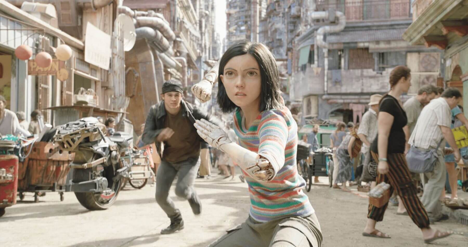 Alita fights while Hugo tries to stop her.