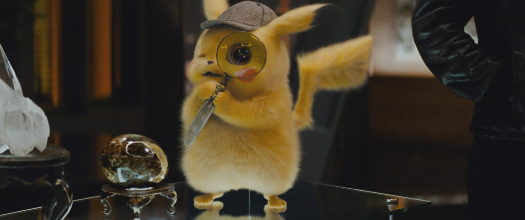 Pikachu looking through a magnifying glass