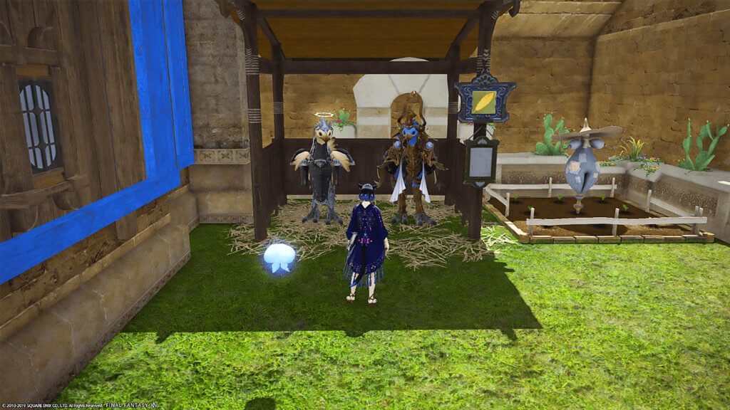 A player with their minion is standing in front of a stable with two chocobos in it.