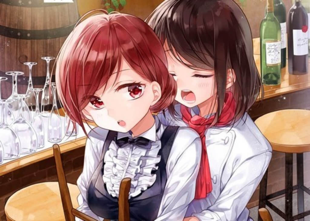 Two women embracing in a bar setting. One is dressed as a chef, the other a waiter.