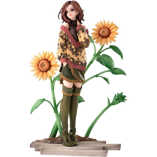 Nana Komatsu wearing comfy sweater with long boots smiling with two large sunflowers behind her.