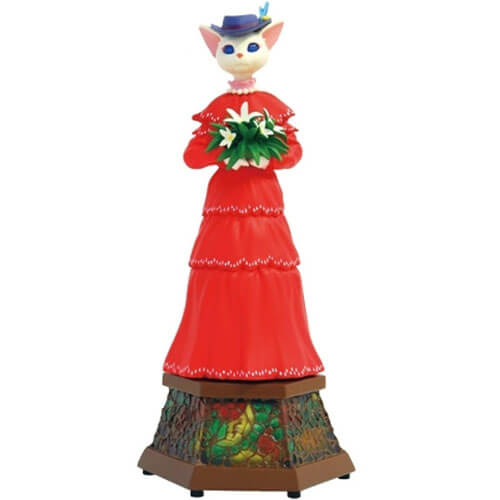 Lousie holding a bouquet of flowers and standing on a pedestal adored with stained glass.