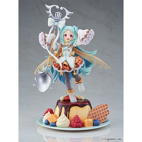 Miyako holding a giant ornamented spoon standing on top of flan pudding.