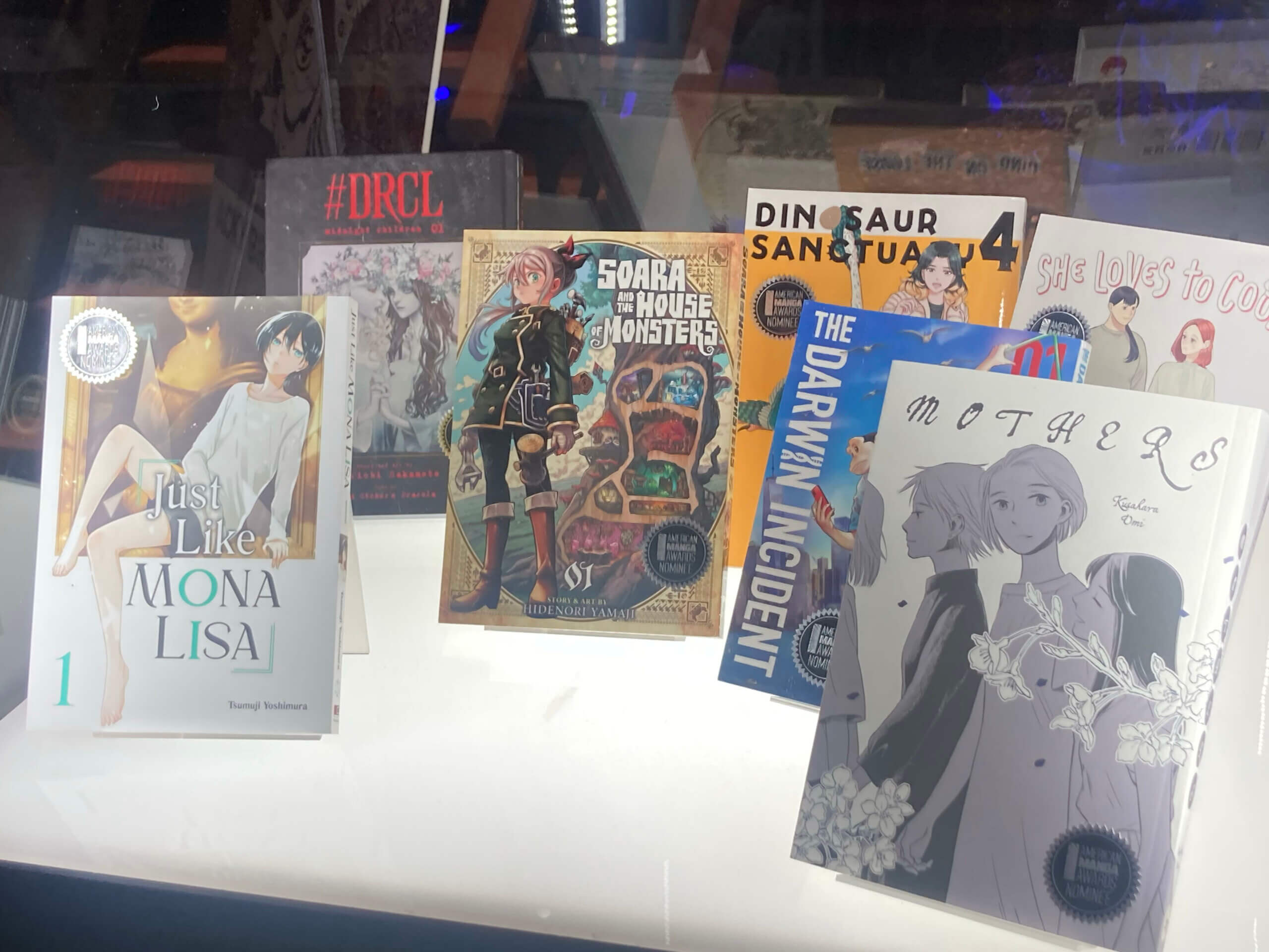 Close-up of nominees for Best New Manga within display case.