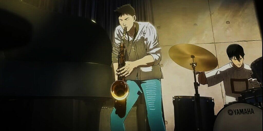 Image is a black haired young man in a white shirt and blue pants playing the sax. In the background is a black haired young man with an expression of concentration playing a drumset.