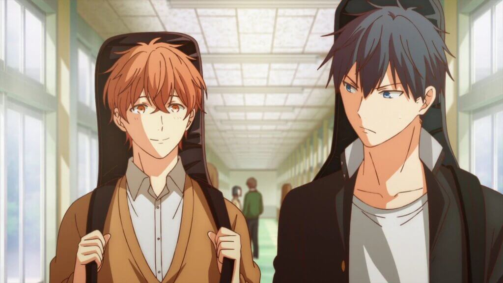 Image is Mafuyu and Ritsuka, the main protagonists of Given. Mafuyu is smiling and has short red hair, orange eyes, and wearing a white button up and orange sweater while carrying a black guitar case. Ritsuka has black hair, blue eyes, a frown, and is wearing a white t-shirt and black male school uniform while carrying a guitar.