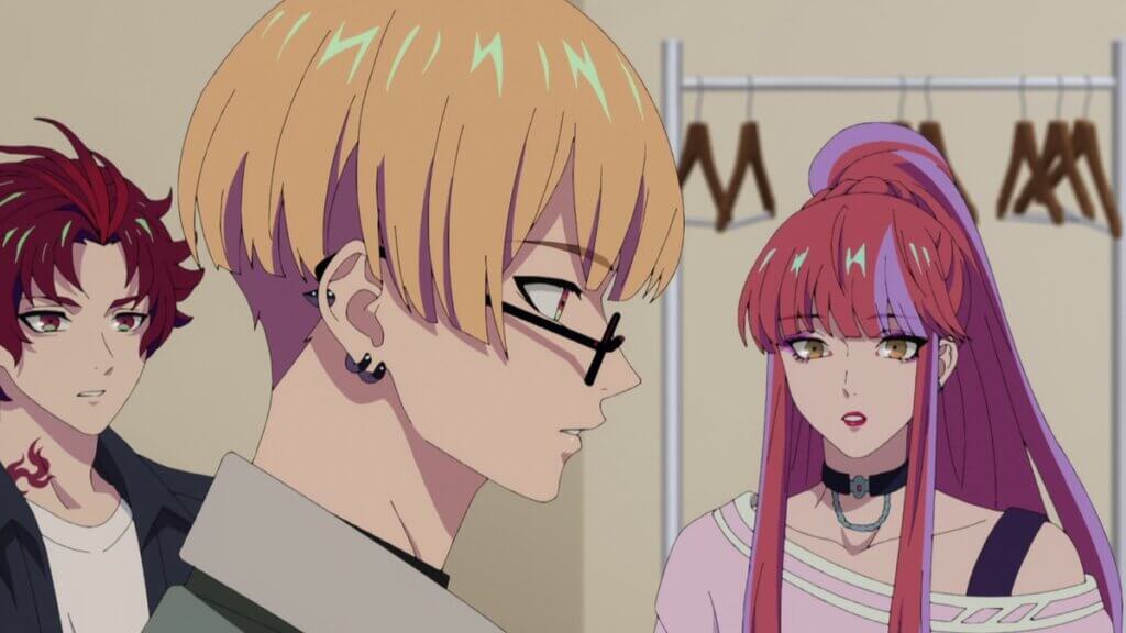 Image is the hip-hop group BAE, a red haired boy with a red tattoo on his neck wearing a white t-shirt and black jacket (Allen), a blonde man with a bowl hair cut, glasses, and earrings on his right ear wearing a green jacket (Yeon), and a long haired nonbinary person with pink hair, purple highlights, lipstick, black choker, wearing an off the shoulder pink top (Anne).