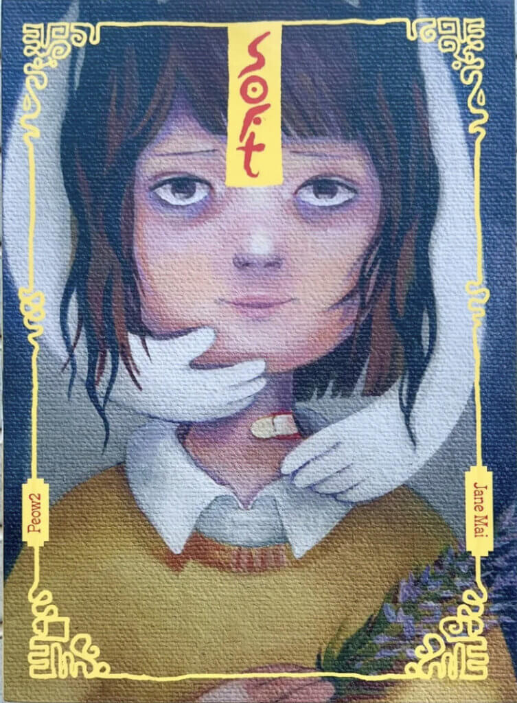 The cover of Soft by Jane Mai. Two white hands grasp the face of a woman wearing a yellow sweater and white shirt.