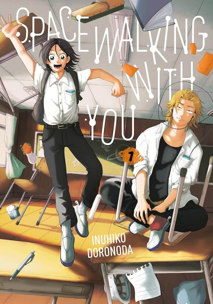 On the cover of Spacewalking with You Vol. 1, objects in a classroom float as if in zero gravity. Uno, a black-haired boy with wide eyes and a big smile, jumps on a desk. Kobayashi, a blond-haired boy with a blasé expression, wears headphones while sitting on an upside-down chair laid atop a desk.