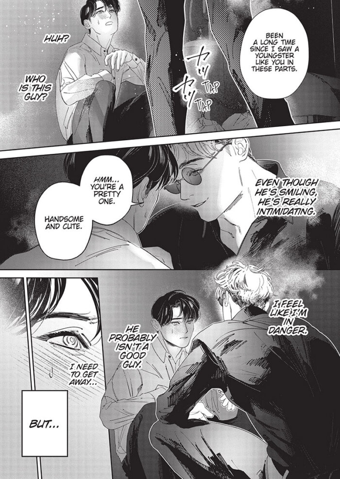 Tenju, a young man with bleached short hair and dark glasses, approaches the drunk Higuchi. Higuchi has short black hair and is dressed in his usual off-work outfit of a button-up shirt and pants. Higuchi looks up from his crouch on the ground next to a wall. Tenju says, “Been a long time since I saw a youngster like you in these parts.” Higuchi thinks, “Huh? Who is this guy? Even though he’s smiling, he’s really intimidating.” Tenju continues, “Hmm…you’re a pretty one. Handsome and cute.” Tenju crouches down to Higuchi’s level, and leans close. Higuchi thinks while staring at Tenju’s face with a blush. “I feel like I’m in danger. He probably isn’t a good guy. I need to get away…but…”