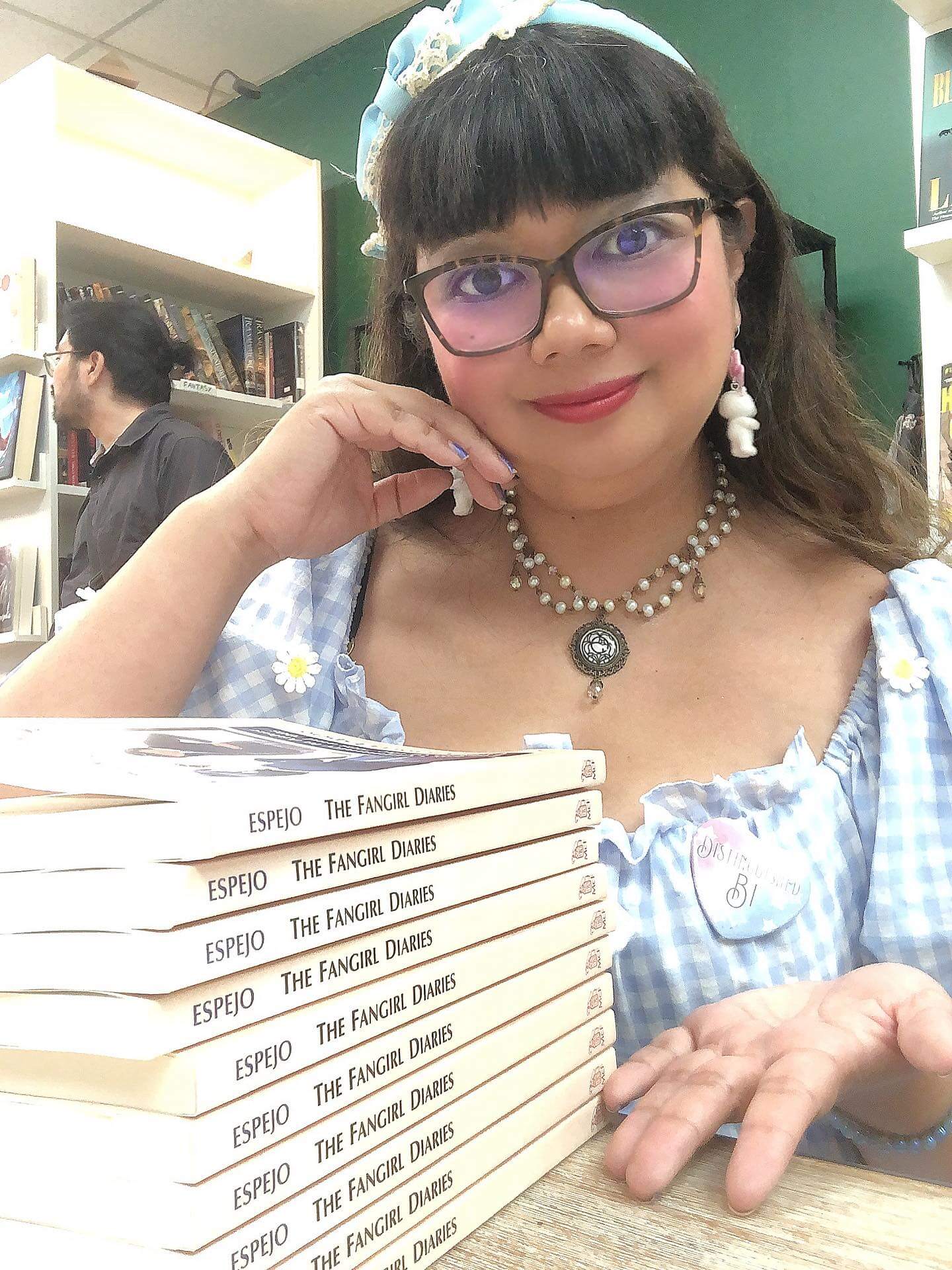 Eri Victoria with a stack of copies of The Fangirl Diaries. Image via Eri Victoria