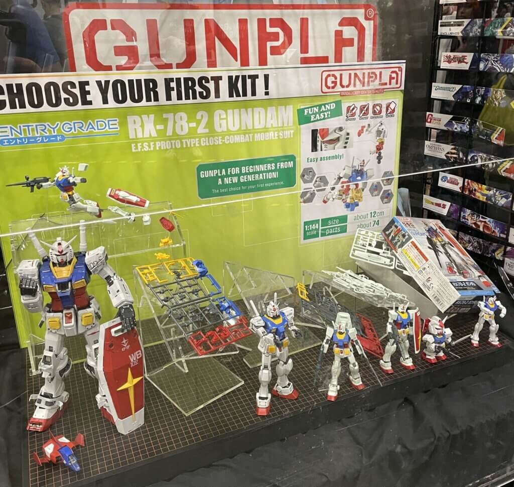 A display of RX-78-2 Gundam Gunpla. The sign reads, "Choose your first kit!" 