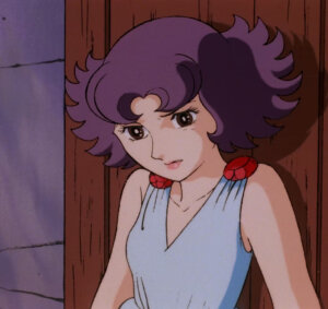 Anime screenshot of Emiya/Prime rose wearing a white dress with red gems on the shoulders. She has a pained expression, and her back is up against a wooden door.