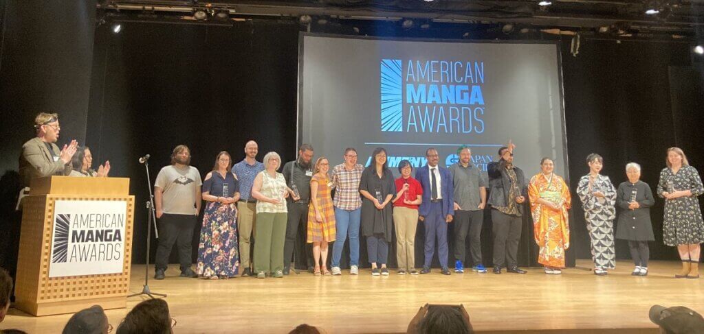 The winners of the American Manga Awards stand together on stage.
