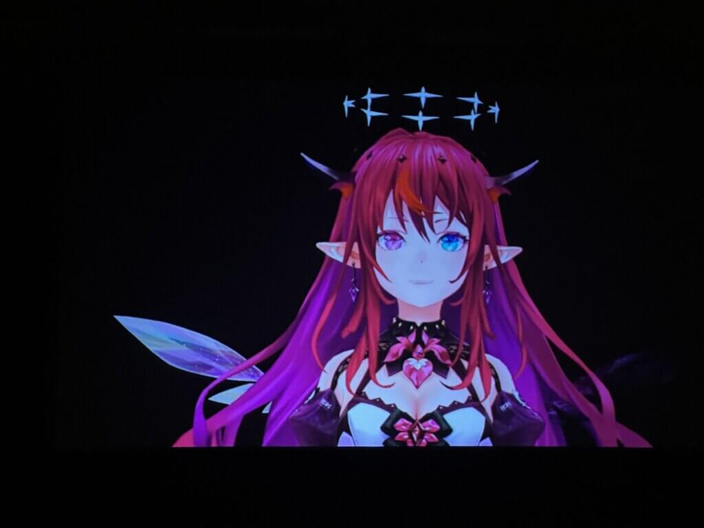 IRyS, a VTuber with horns, purple hair and a halo, presents the award for Best Continuing Manga Series at the American Manga Awards.