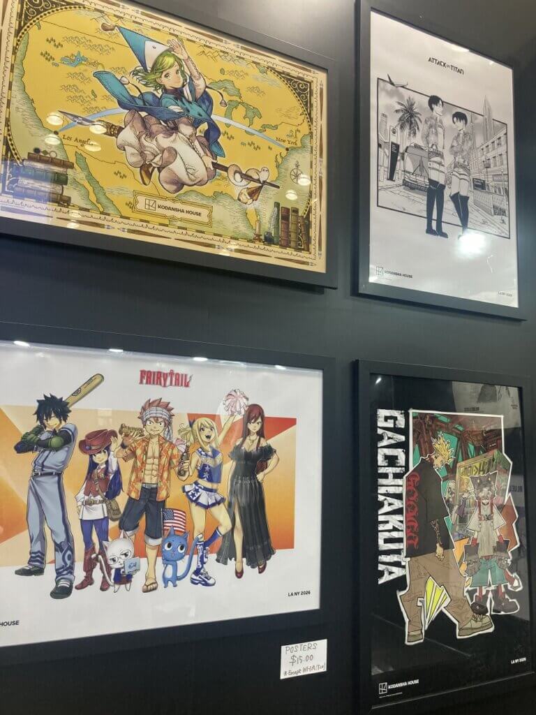 Posters available for sale at the Kodansha booth, featuring Witch Hat Atelier, Attack on Titan, Fairy Tail and Gachiakuta.