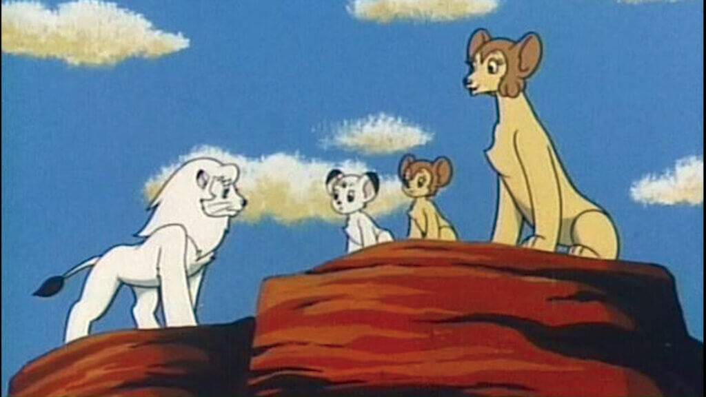 An image from Kimba the White Lion, depicting a white maned lion standing by a female lioness and two lion cubs.